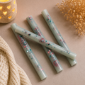 Lenny Midsummer Memories Sticks arranged alongside soft textures and warm light, featuring floral and fruity designs.